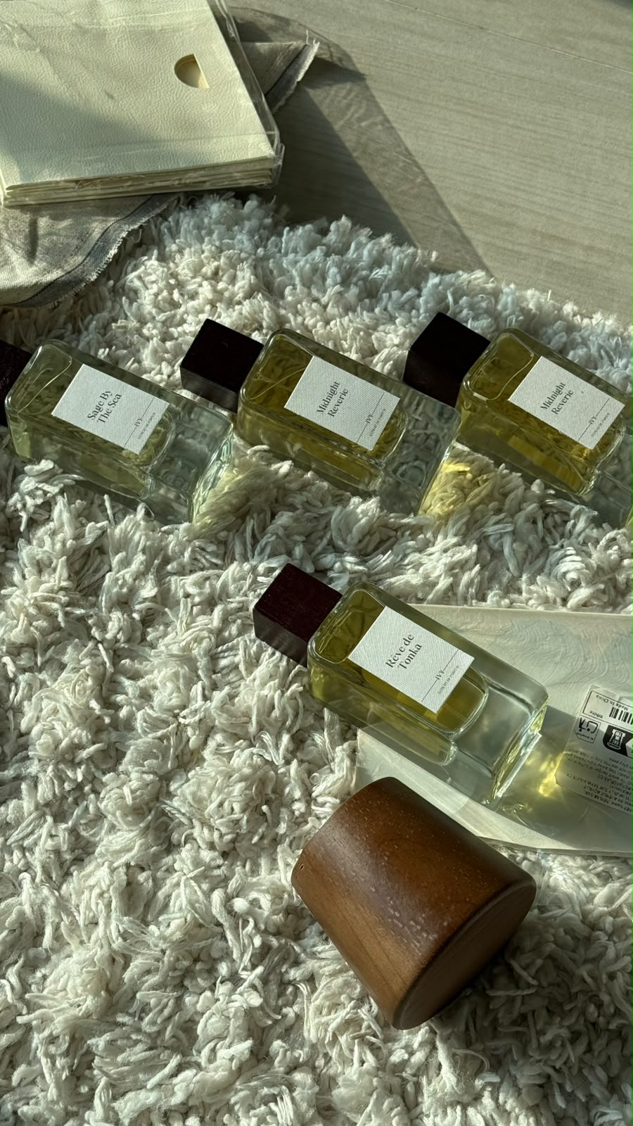 IVY perfumes arranged on ivory packaging in warm sunlight